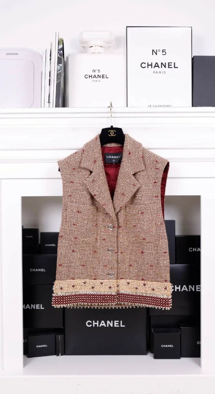 Chanel 23A Dakar Collection Show Style, the same style worn by Wang Yibo. Brown, two-pocket vest with heavy beaded trim.