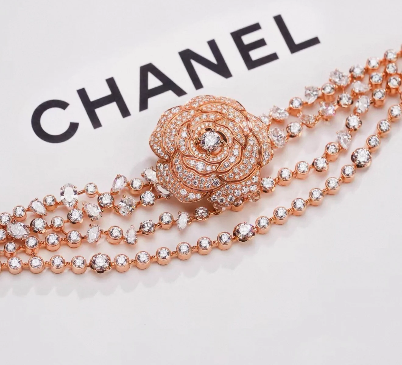 Chanel "Camélia Garden" high jewelry collection features a rose gold tassel chain with full diamonds, detachable camellia brooch, bracelet, and bangle. - Image 6